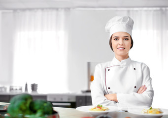 Portrait of female chef in kitchen