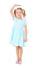 Little girl measuring height on white background