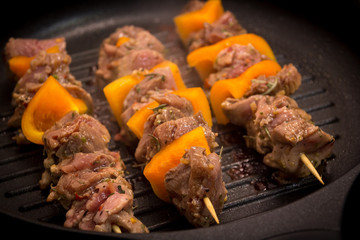 Pork skewer kebab on stove top grill