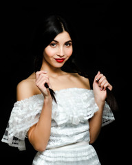 Fototapeta premium Beauty fashion portrait of a cute woman. Retro lady with pigtails, isolated on studio black background.