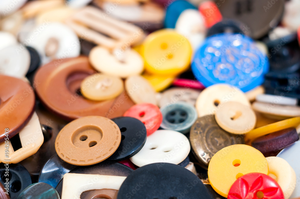 Poster many different sized and shaped buttons closeup