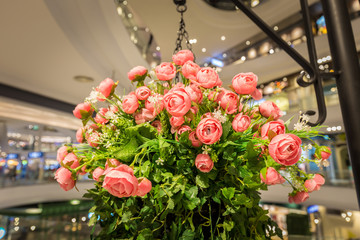 Artificial rose Flowers hanging on pillar in shopping mall