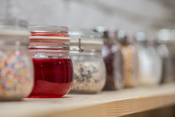 Close up of strawberry yam in Glass jar with topping for ice cream