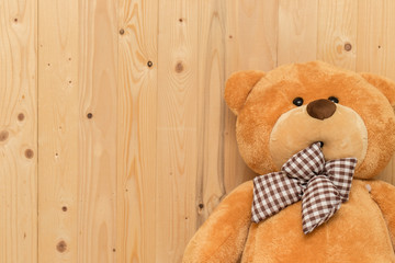 Teddy bear with wooden wall,Copy space