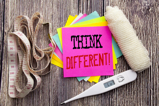 Handwriting Announcement text Think Different. Business fitness health concept for Outside Box Creative written sticky note empty paper background with bandage and thermometer
