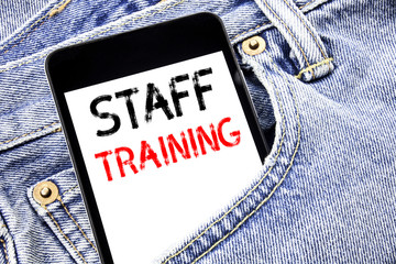 Handwriting Announcement text showing Staff Training. Business concept for Teaching or Education Written phone mobile phone, cellphone placed in the man front jeans pocket.