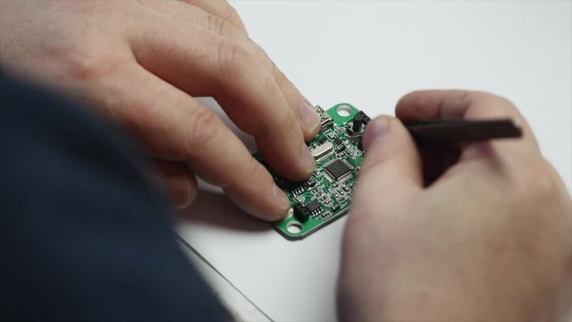 electronic engineer soldering circuit perfboard