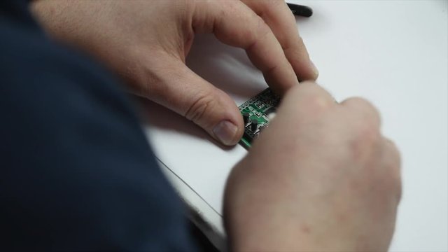 electronic engineer soldering circuit perfboard