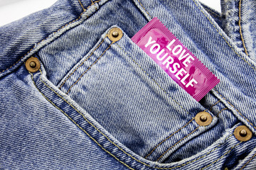 Handwriting Announcement text showing Love Yourself. Business concept for Positive Slogan For You Written on condom pack put in the small pocket to pants jeans.