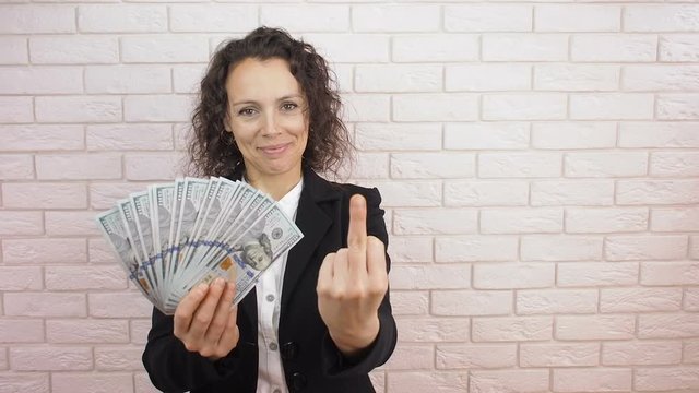 Middle finger. Business woman with money shows middle finger.