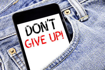 Handwriting Announcement text showing Don t Give Up. Business concept for Motivation Determination, Written phone mobile phone, cellphone placed in the man front jeans pocket.