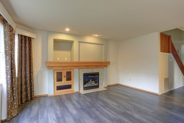 Light filled newly Updated living room interior with traditional fireplace.