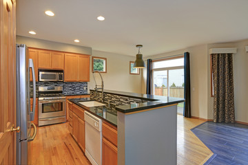 Small compact kitchen room with light wood cabinetry