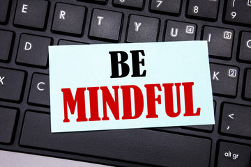 Word, writing Be Mindful. Business concept for Mindfulness Healthy Spirit written on sticky note paper on the black keyboard background.