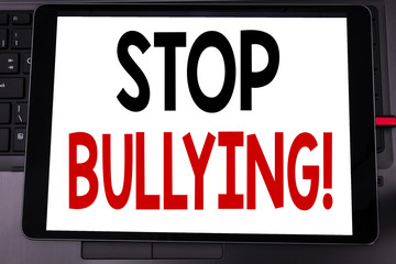 Conceptual hand writing text caption inspiration showing Stop Bullying. Business concept for Prevention Problem Bully written on tablet laptop on the black keyboard background.