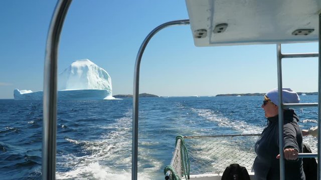 Editorial tourist boat look at ice berg floating by twillingate Newfoundland