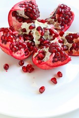 Fresh Juicy Pomegranate on White Plate