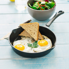Vegetarian dinner table. Plate with black quinoa and oatmeal cutlets with prunes on white wooden table close up