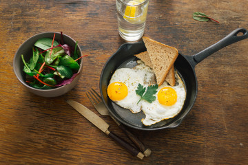 Vegetarian dinner table. Plate with black quinoa and oatmeal cutlets with prunes on white wooden table close up