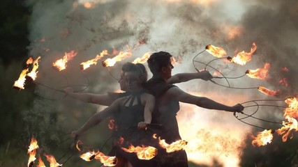 Artists spinning with fire staffs 