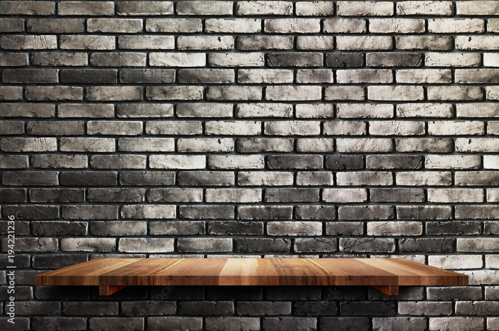 Poster empty wood board shelf at black brick wall background,mock up for display or montage of product or d
