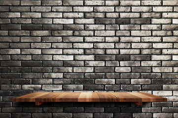 Empty wood board shelf at black brick wall background,Mock up for display or montage of product or design