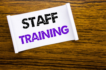 Word, writing Staff Training. Business concept for Teaching or Education written on sticky note paper on the wooden wood structure visible background.