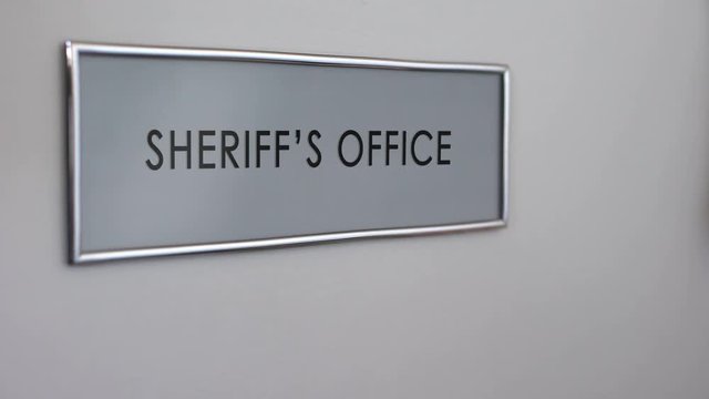 Sheriff office door, hand knocking, law enforcement officer, crime prevention
