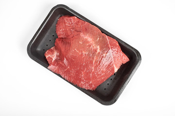 fresh raw beef in a package isolated on white background