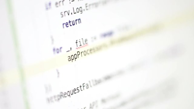 Close-up of the computer screen on which the programmer is running. On white background hacker writes a virus program for a security failure.