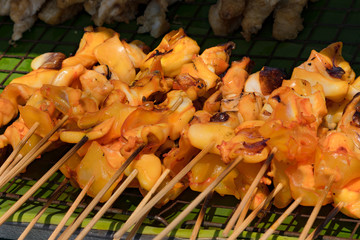 Nice seafood barbecue. Grilled squid on skewer
