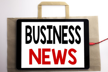 Handwriting Announcement text showing Business News. Business concept for Modern Online News Written on shopping bag and tablet with white background, tablet charging.