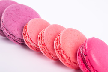 tilted stack of cookies macaron pink, on with a wooden background