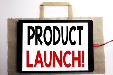 Handwriting Announcement text showing Product Launch. Business concept for New Products Start Written on shopping bag and tablet with white background, tablet charging.
