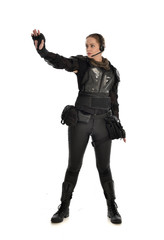 Fototapeta premium full length portrait of female soldier wearing black tactical armour with arms raised, isolated on white studio background.