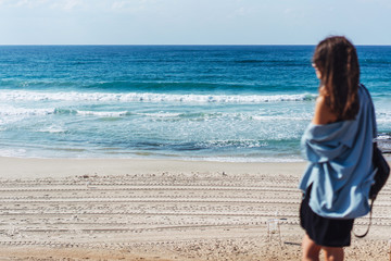 Young beautiful girl looks afar at sea