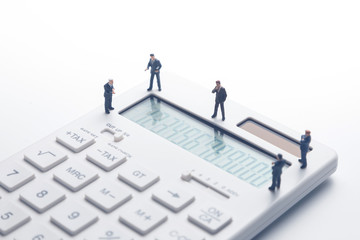 Group of people watching a calculator.