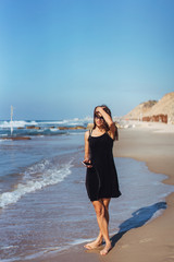 Young beautiful girl posing by the sea