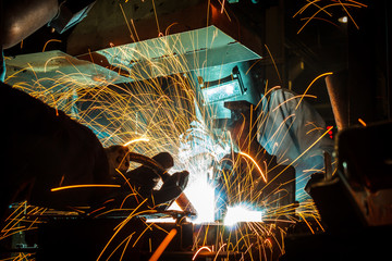 worker with protective mask welding metal