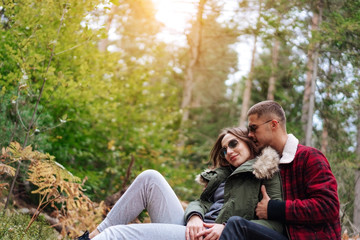 Fototapeta premium guy kisses his girlfriend in the forest
