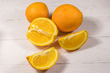 Fresh oranges on white wooden table