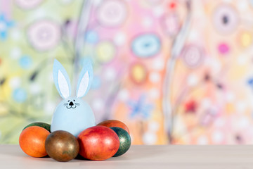 Background with Easter eggs and blue rabbit