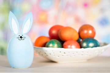 Fototapeta na wymiar Easter decoration with rabbit and painted eggs