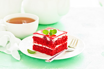 a piece of delicious red velvet cake on a plate.