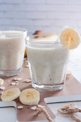 Banana chilled smoothies with banana, milk, almonds and honey, selective focus