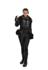 full length portrait of female  soldier wearing black  tactical armour with arms raised, isolated on white studio background.