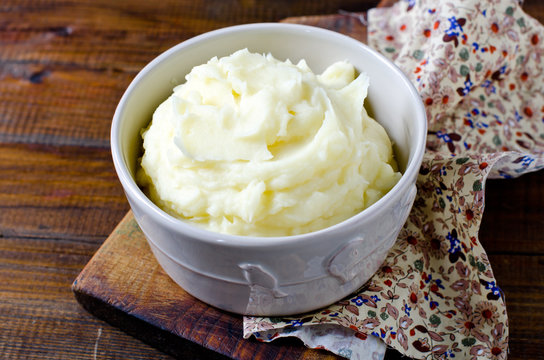 Mashed potatoes in a bowl on a wooden table