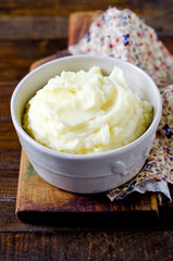 Mashed potatoes in a bowl on a wooden table