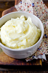 Mashed potatoes in a bowl on a wooden table