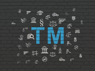 Law concept: Painted blue Trademark icon on Black Brick wall background with  Hand Drawn Law Icons